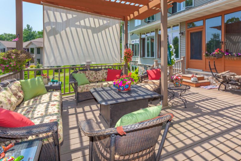 free standing pergola with colourful outdoor furniture