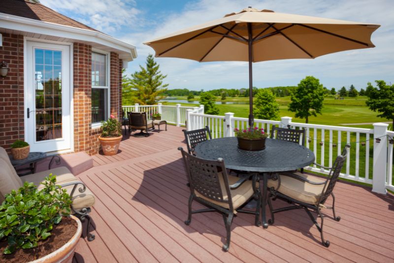outdoor composite deck with dining area and umbrella
