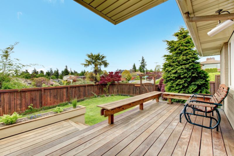 back verandah with a chair overlooking the lawn