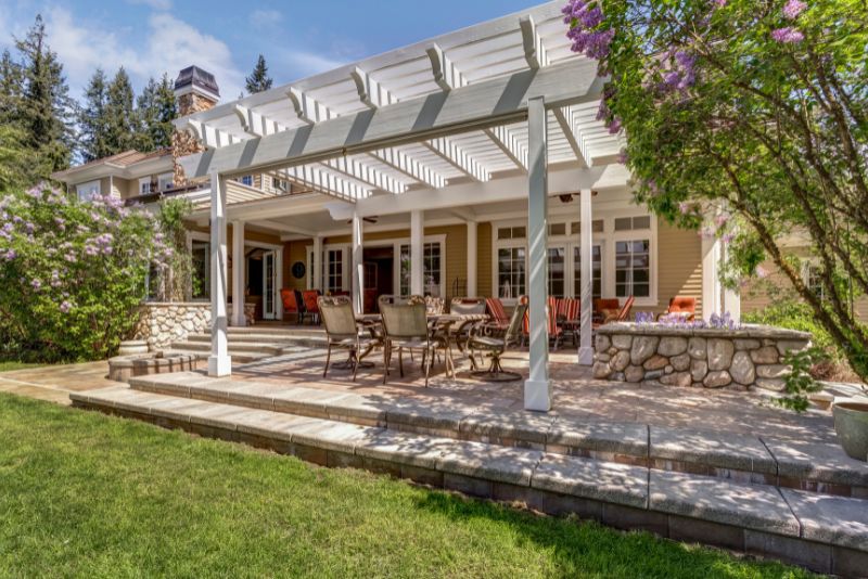 stylish pergola with a fire pit and a lounge area