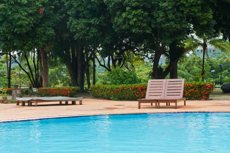 stone pool deck with two lounge chairs
