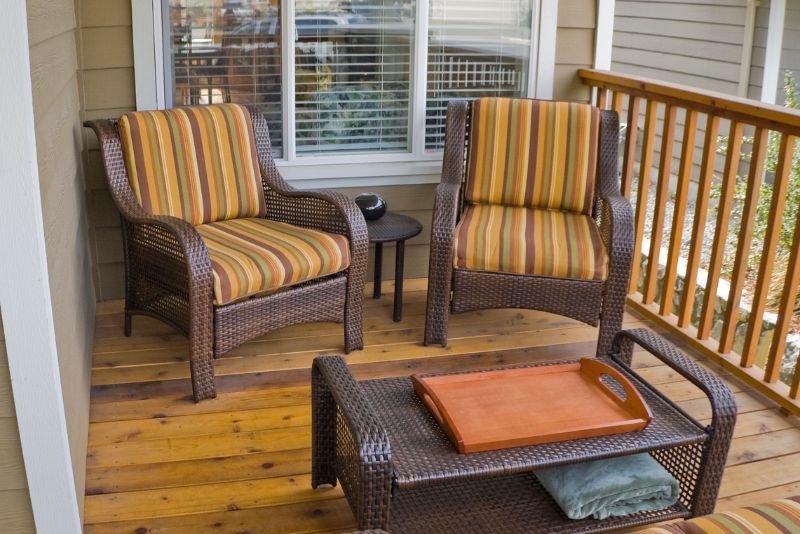 hardwood deck with rattan chairs and table
